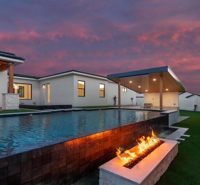 There is a fire pit in the middle of the patio.