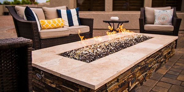 There is a fire pit in the middle of the patio.