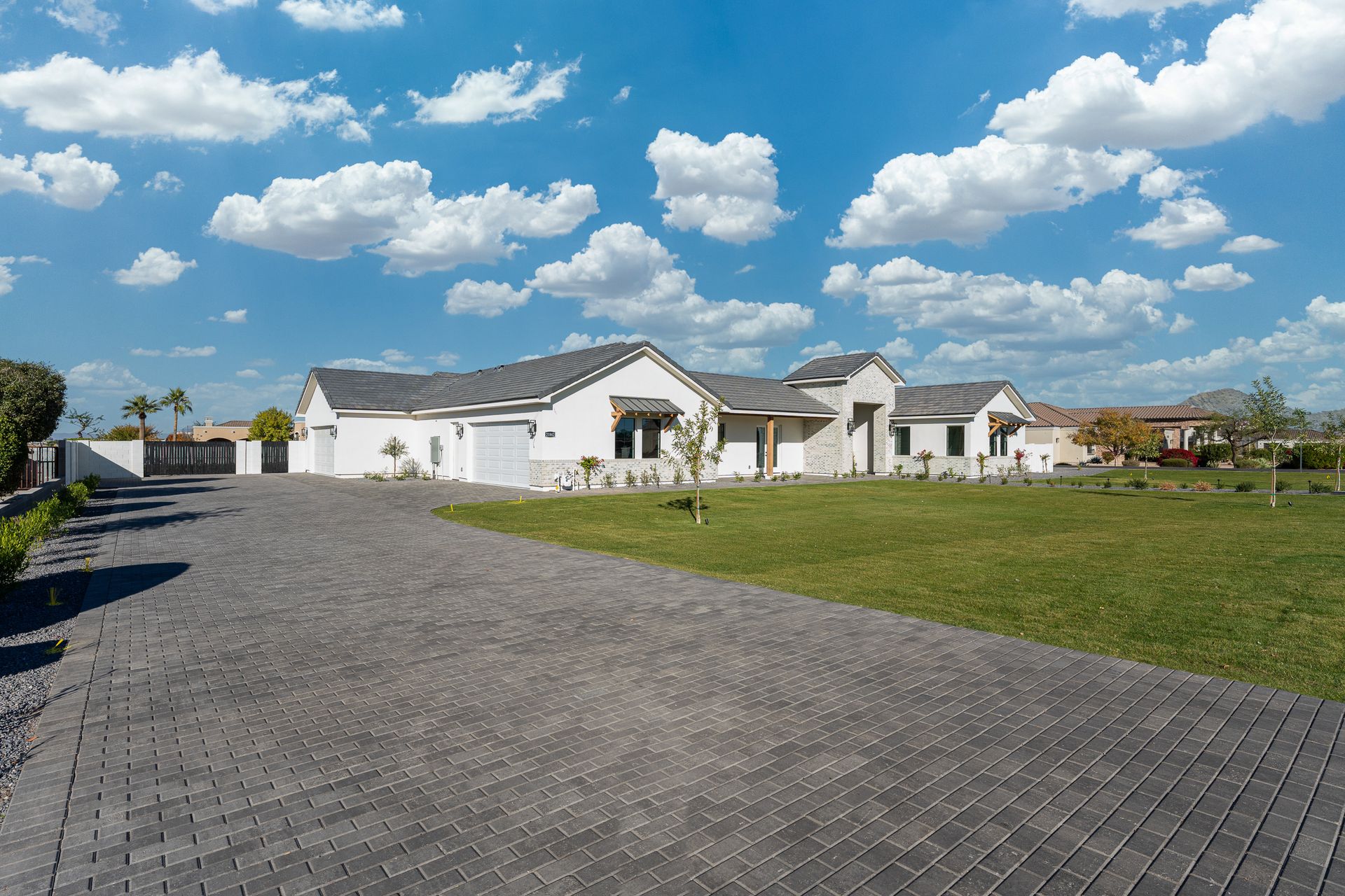 A large white house with a driveway leading to it