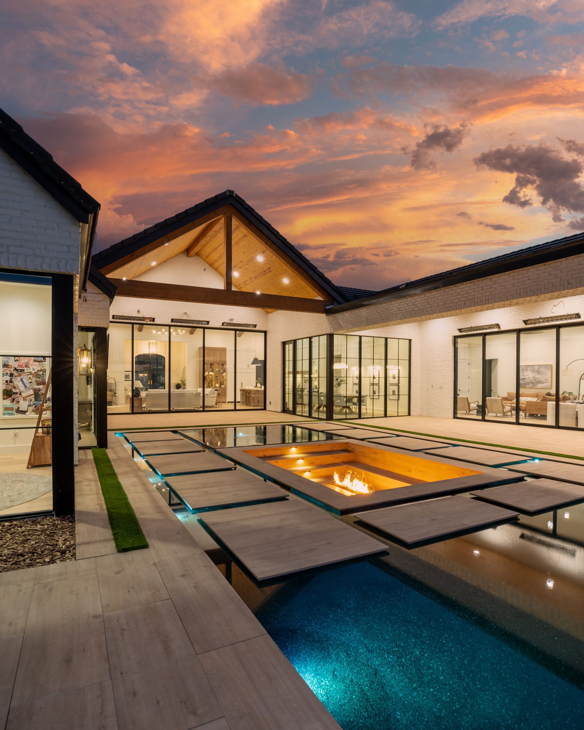 A large house with a swimming pool in the middle of it