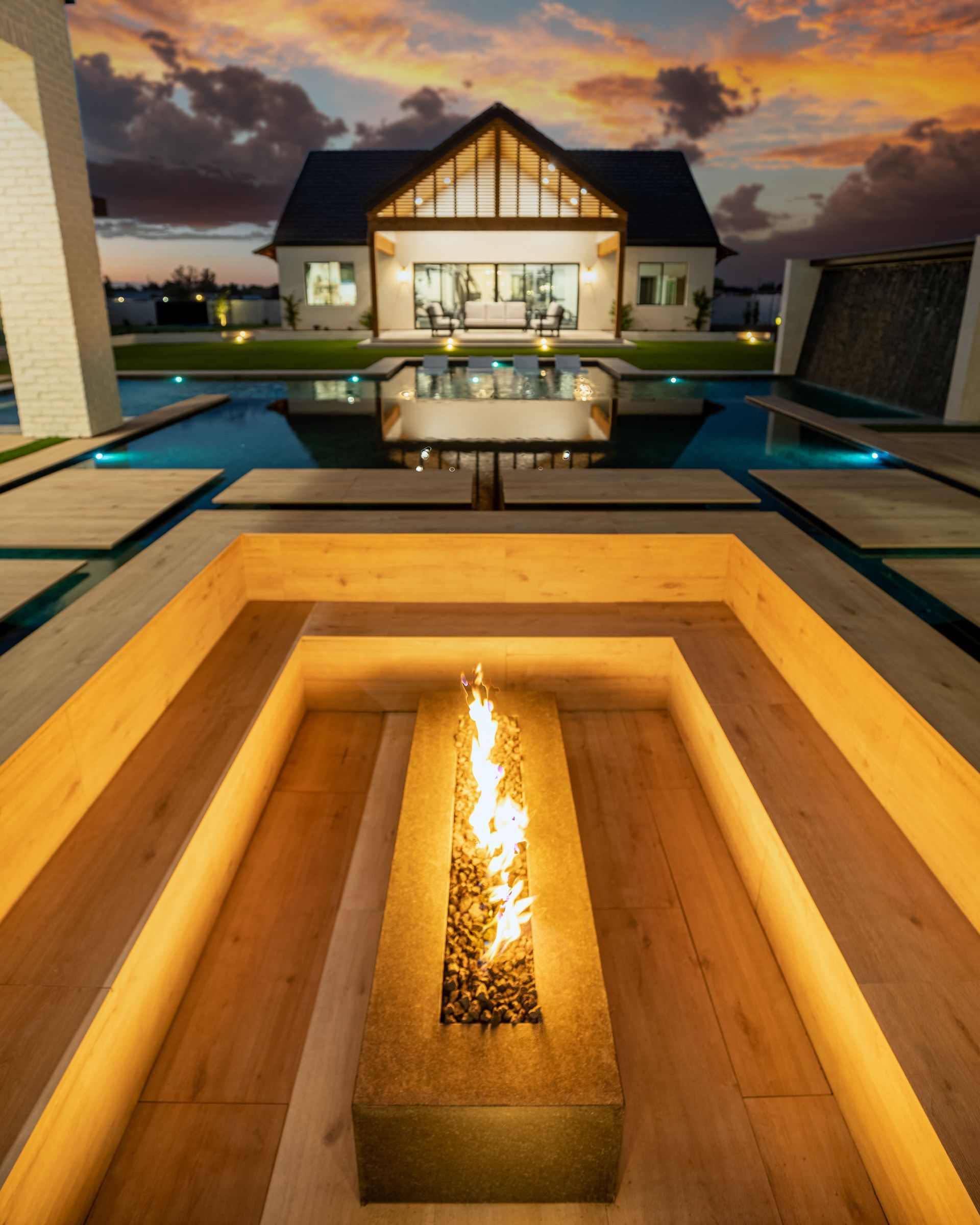 A large house with a fire pit in front of it