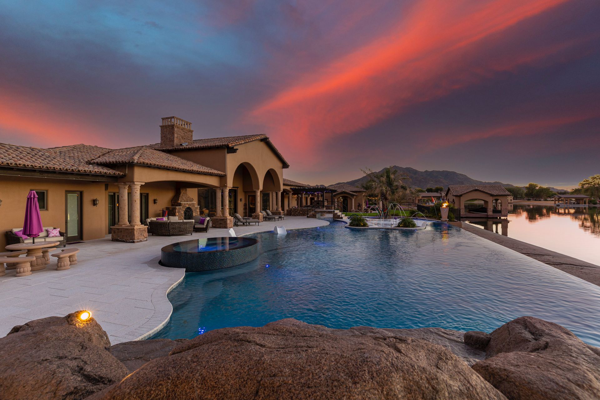 A large house with a large swimming pool in front of it.