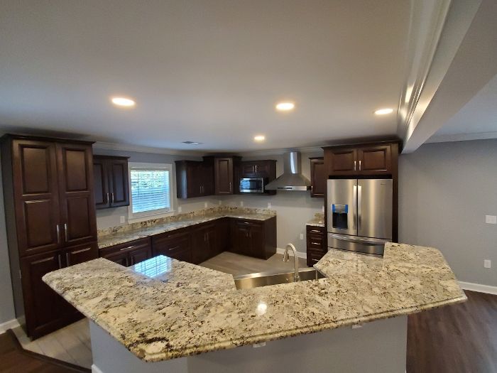 A kitchen with granite counter tops and stainless steel appliances.