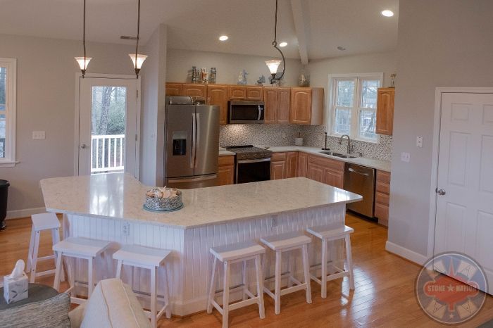 There is a large island in the middle of the kitchen.