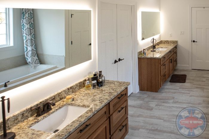 A bathroom with two sinks and two mirrors.