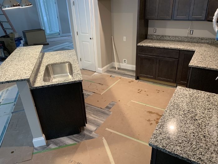 A kitchen with granite counter tops and stainless steel sink.
