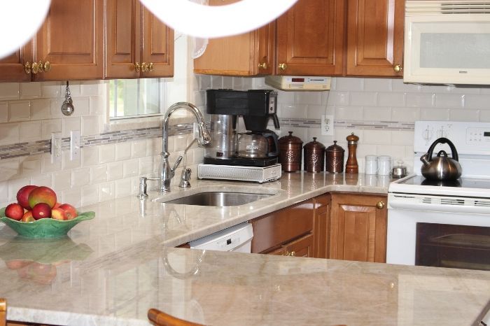 A kitchen with a bowl of apples on the counter