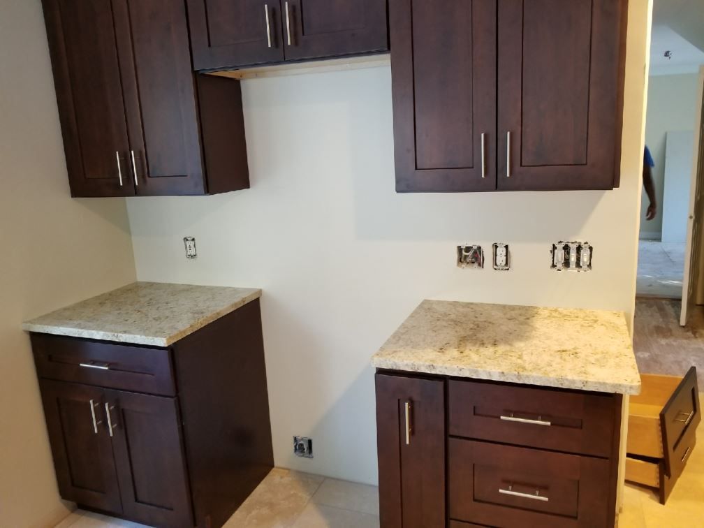 A kitchen with wooden cabinets and granite counter tops