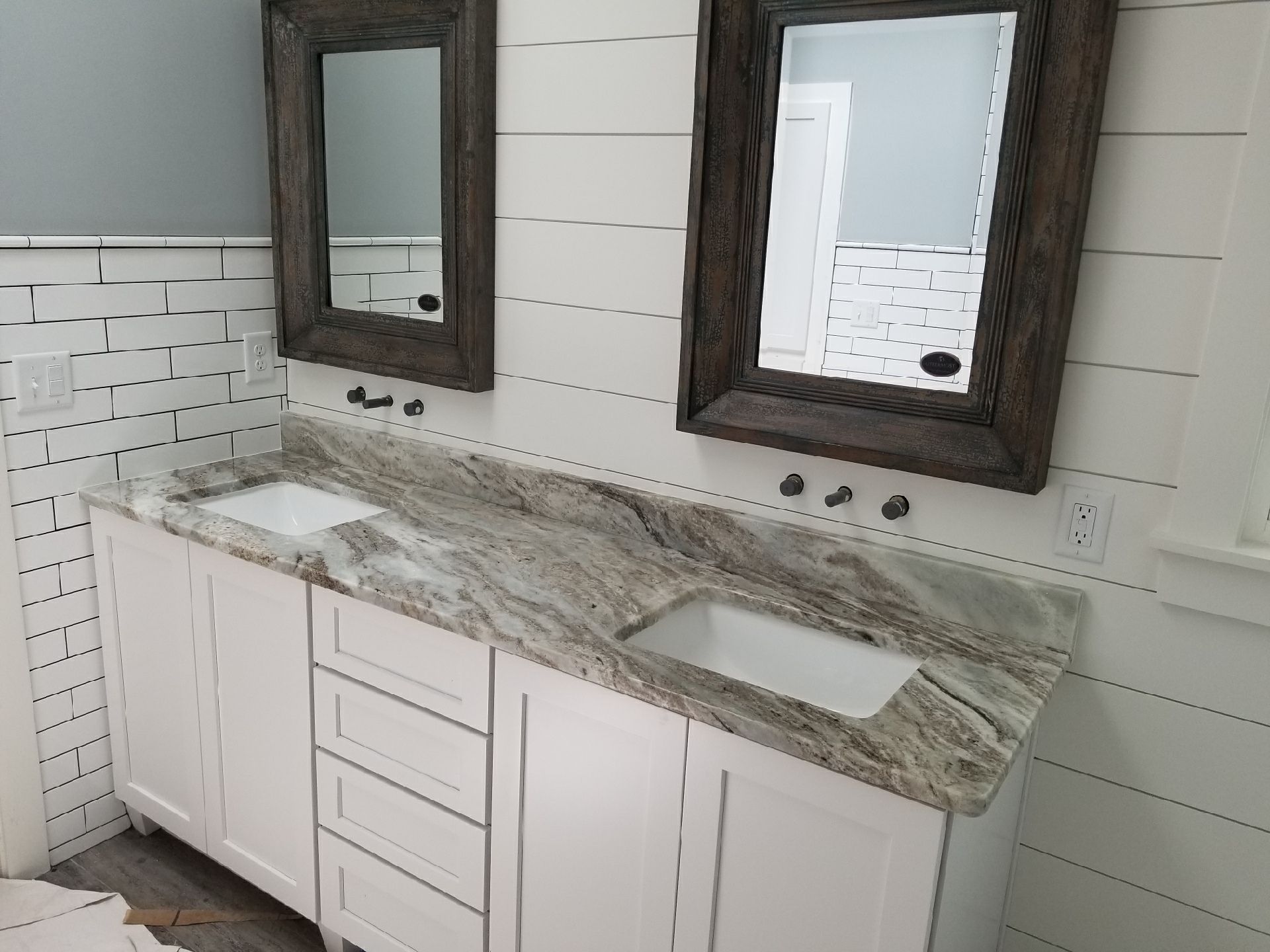 A bathroom with two sinks and two mirrors.
