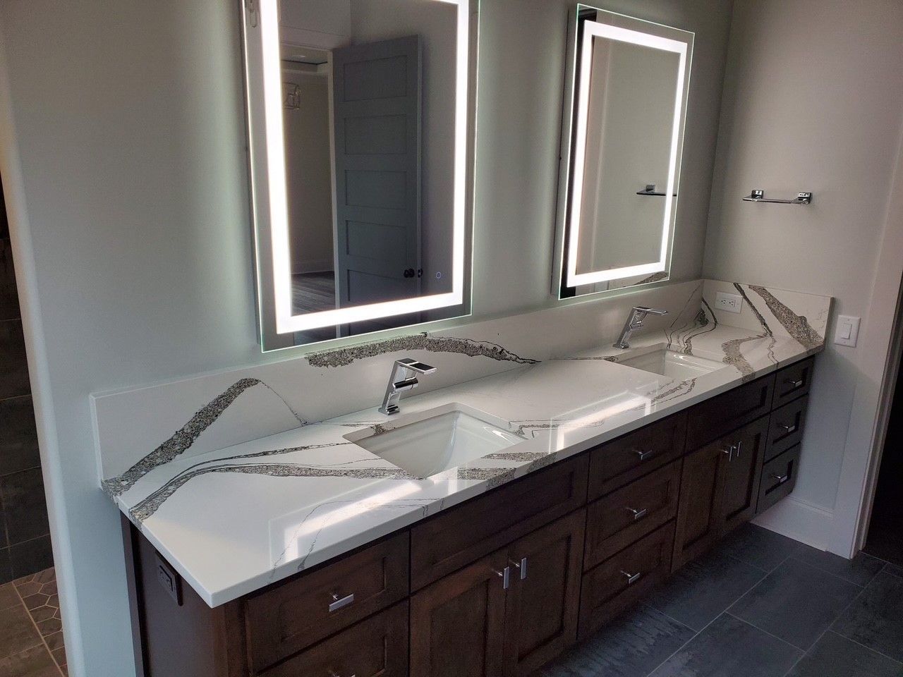 A bathroom with two sinks and two mirrors.