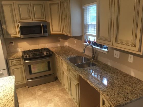 A kitchen with granite counter tops and stainless steel appliances