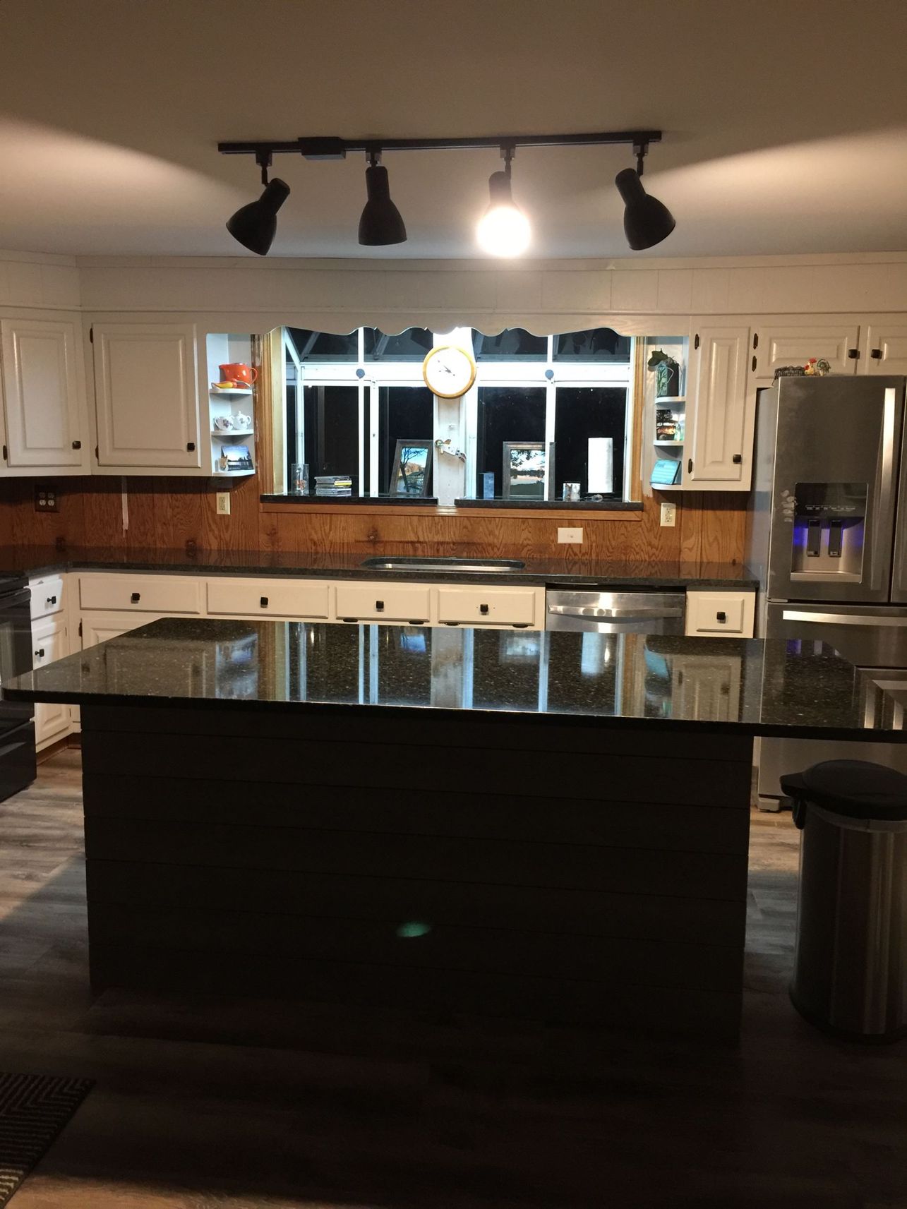 A kitchen with a large island in the middle