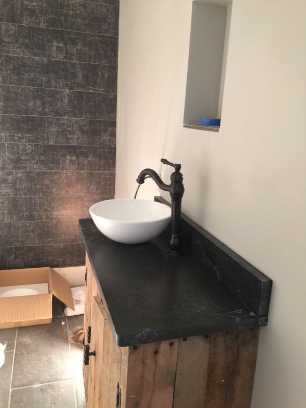 A bathroom with a sink and a mirror on the wall