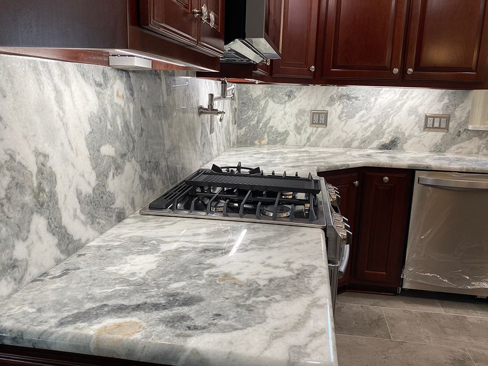 A kitchen with a stove top oven and a dishwasher.