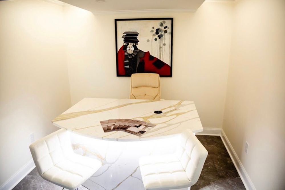 A conference room with a table and chairs and a painting on the wall