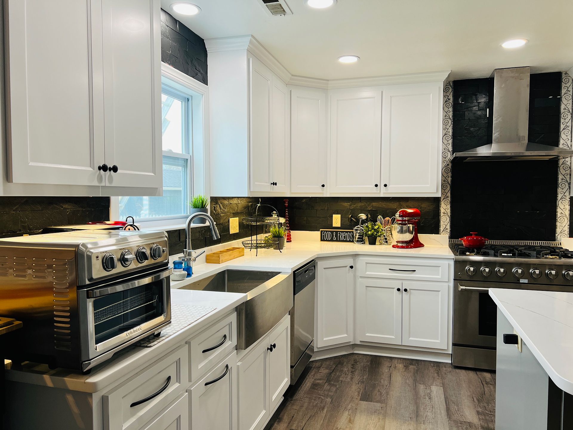 A kitchen with white cabinets and stainless steel appliances.
