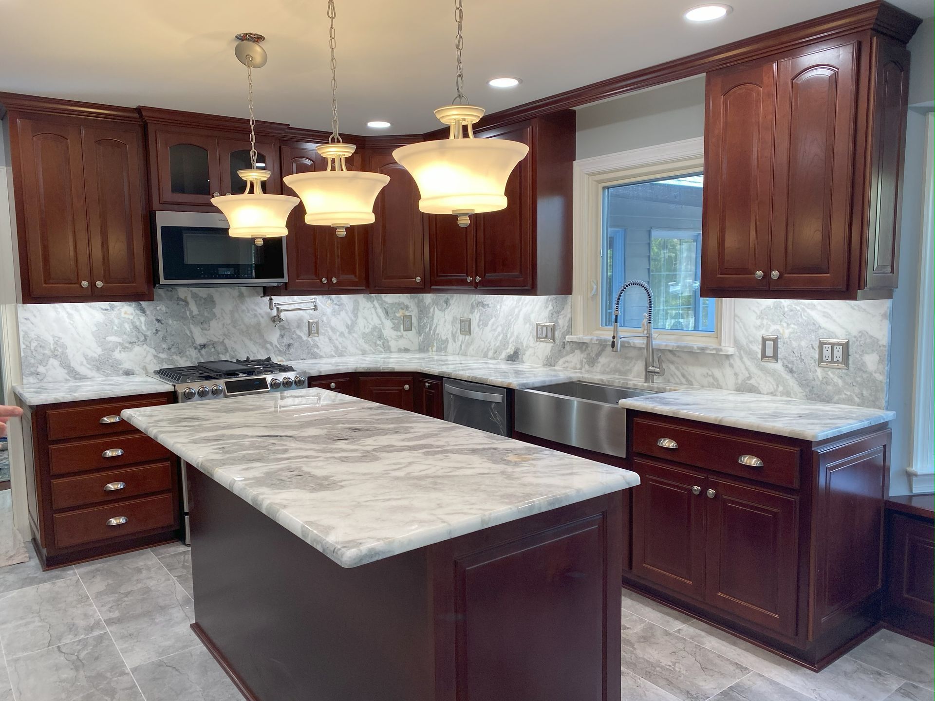 A kitchen with a large island and stainless steel appliances