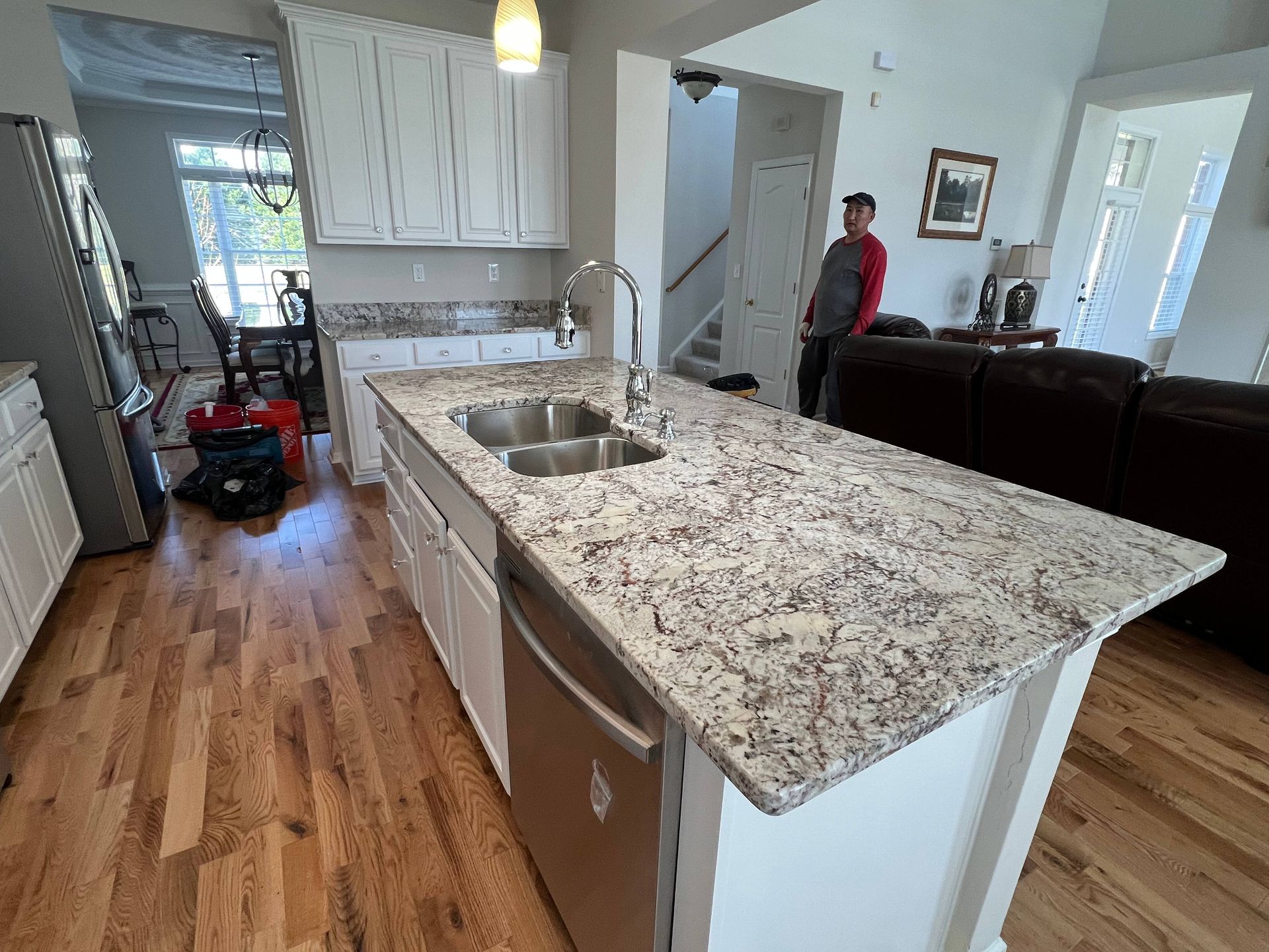 A kitchen with granite counter tops and stainless steel appliances.