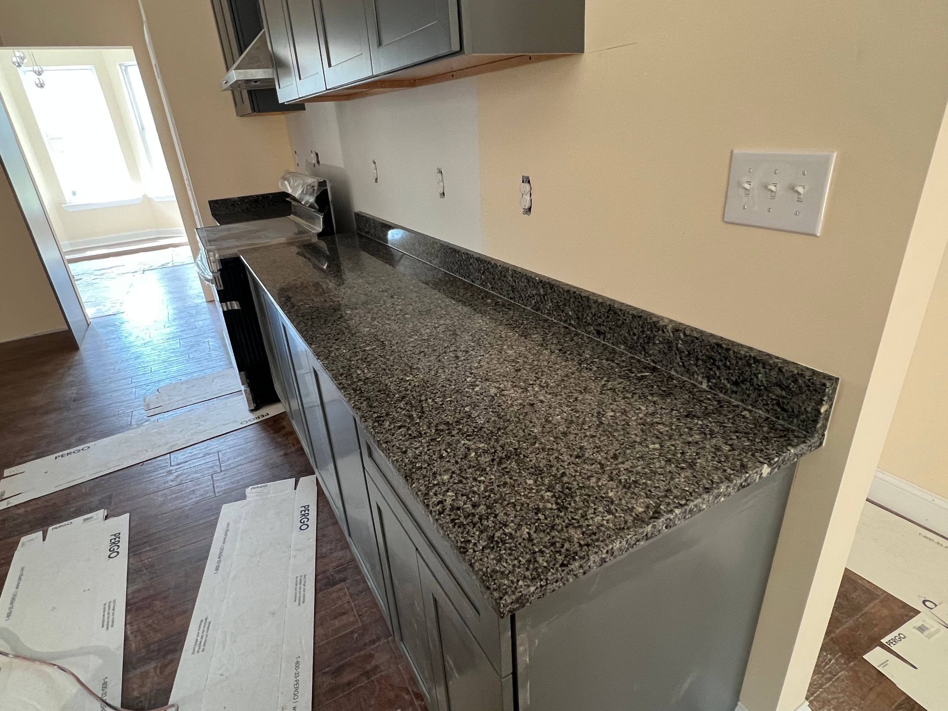 A kitchen with granite counter tops and stainless steel appliances
