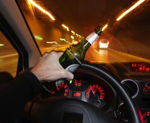 Hand holding a beer while driving