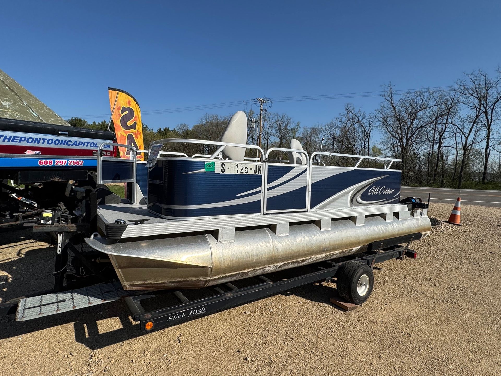 A pontoon boat is sitting on top of a trailer.