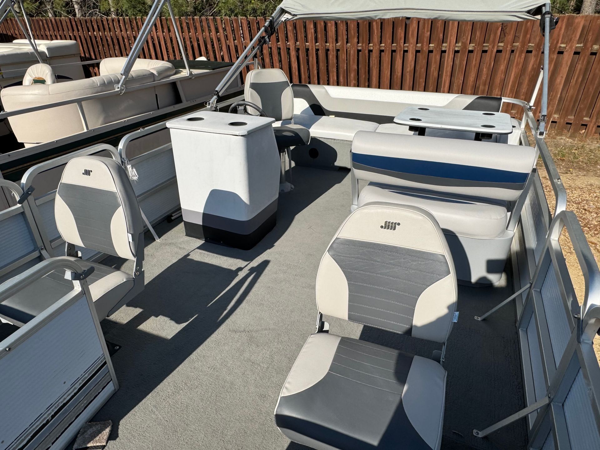 The inside of a boat with a wooden fence in the background