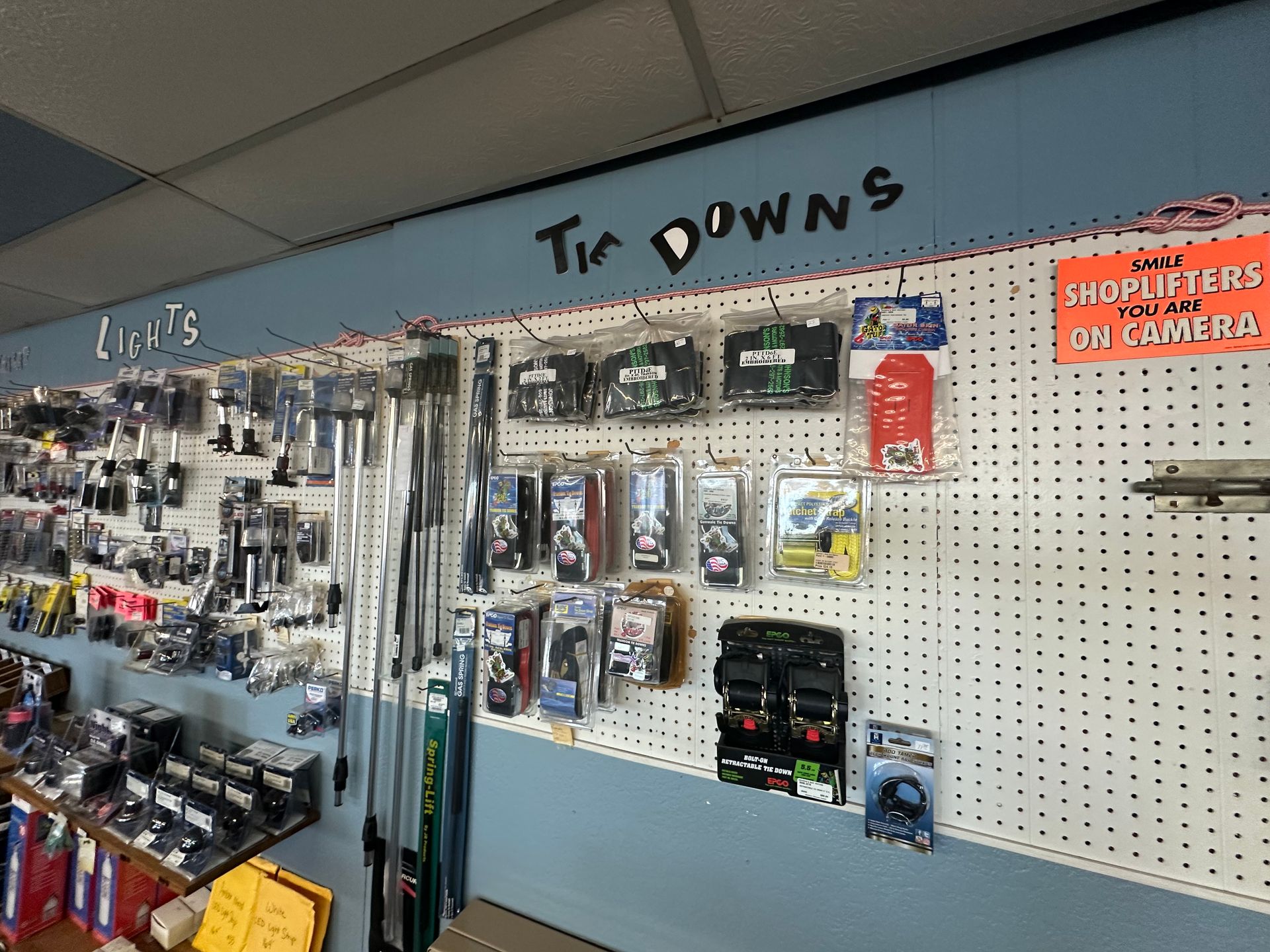 A wall with a lot of tools on it and a sign that says tic downs