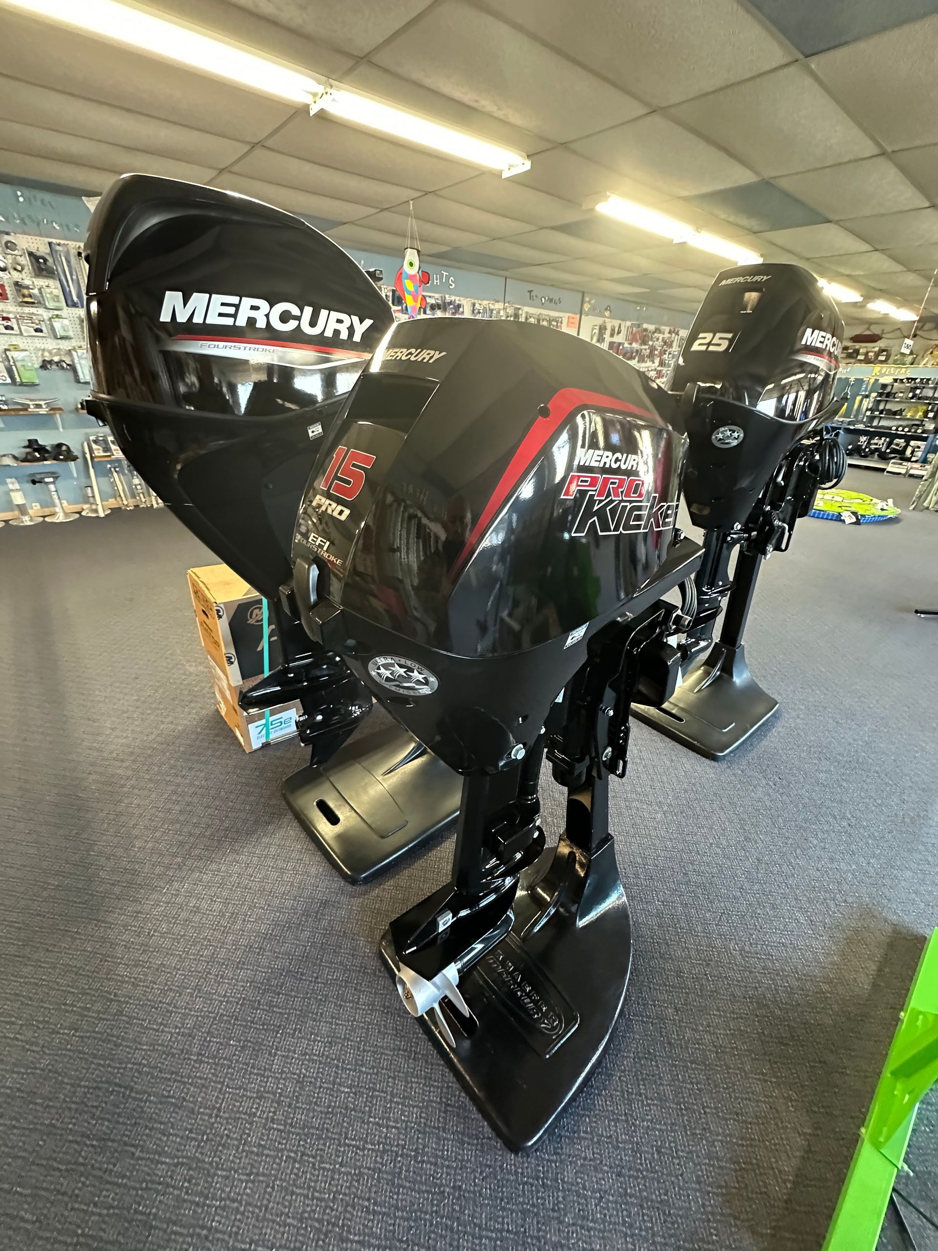 A mercury outboard motor is on display in a store.