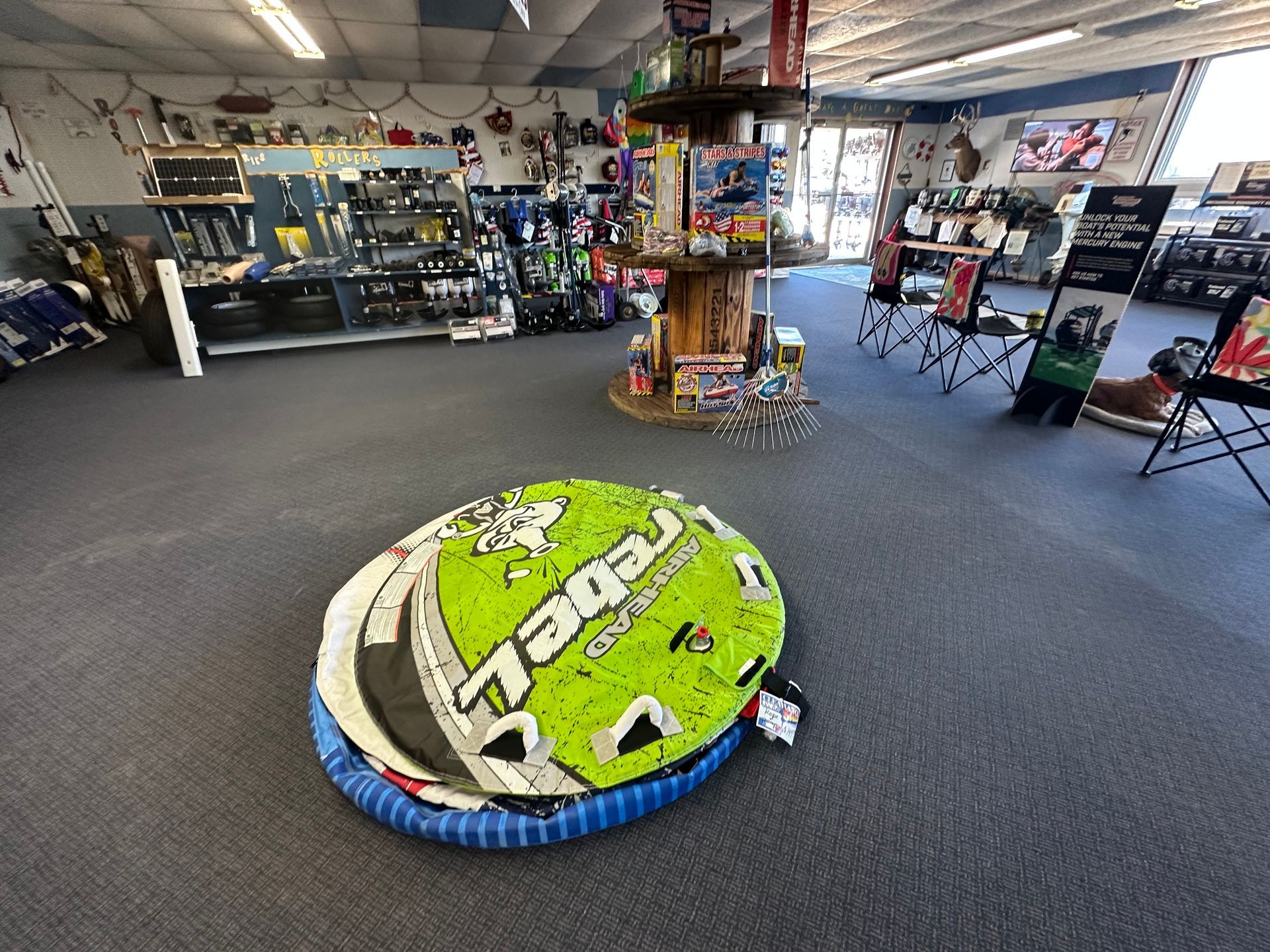 A green tube is sitting on the floor in a store.