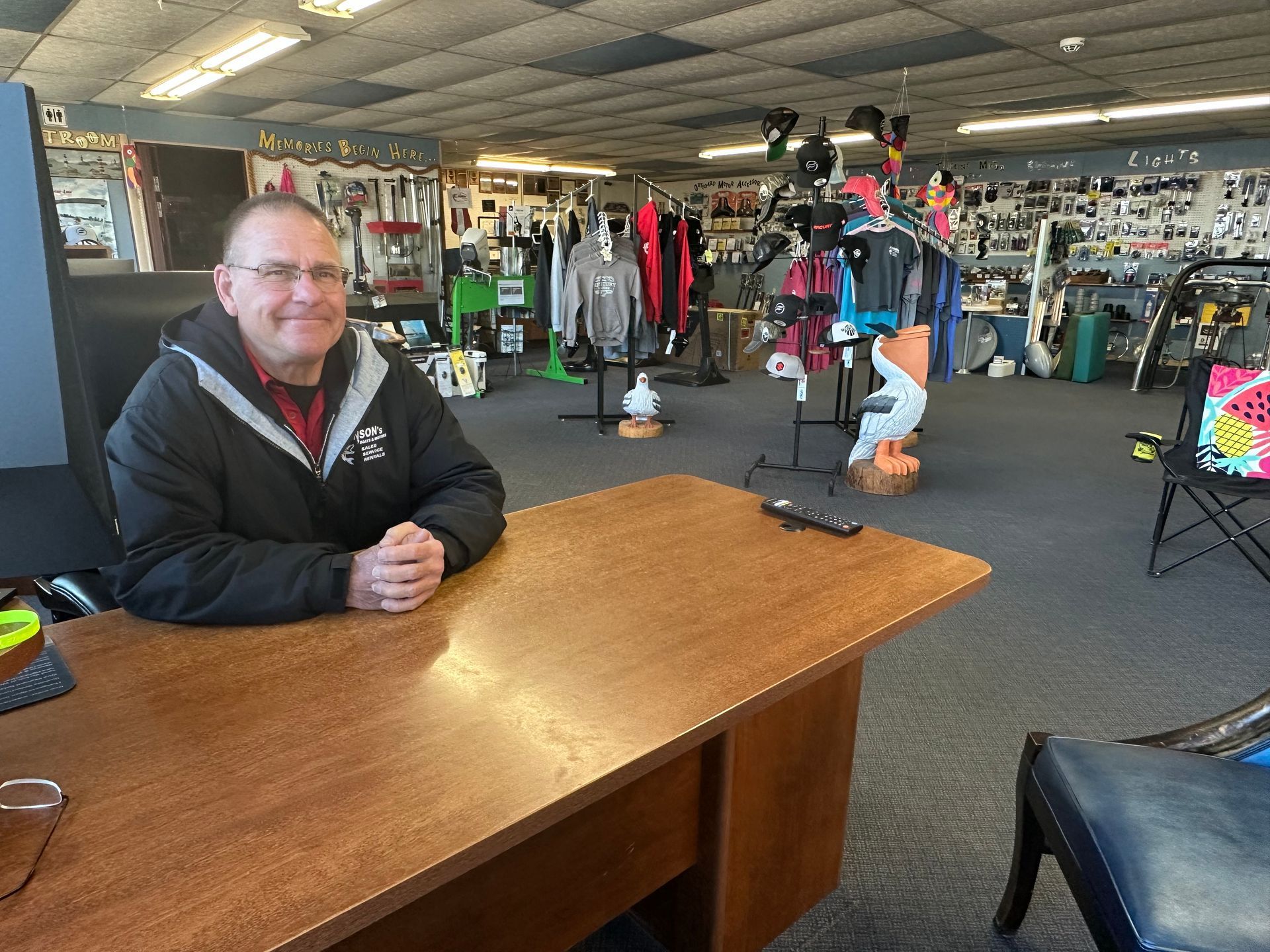 A man is sitting at a desk in a store.