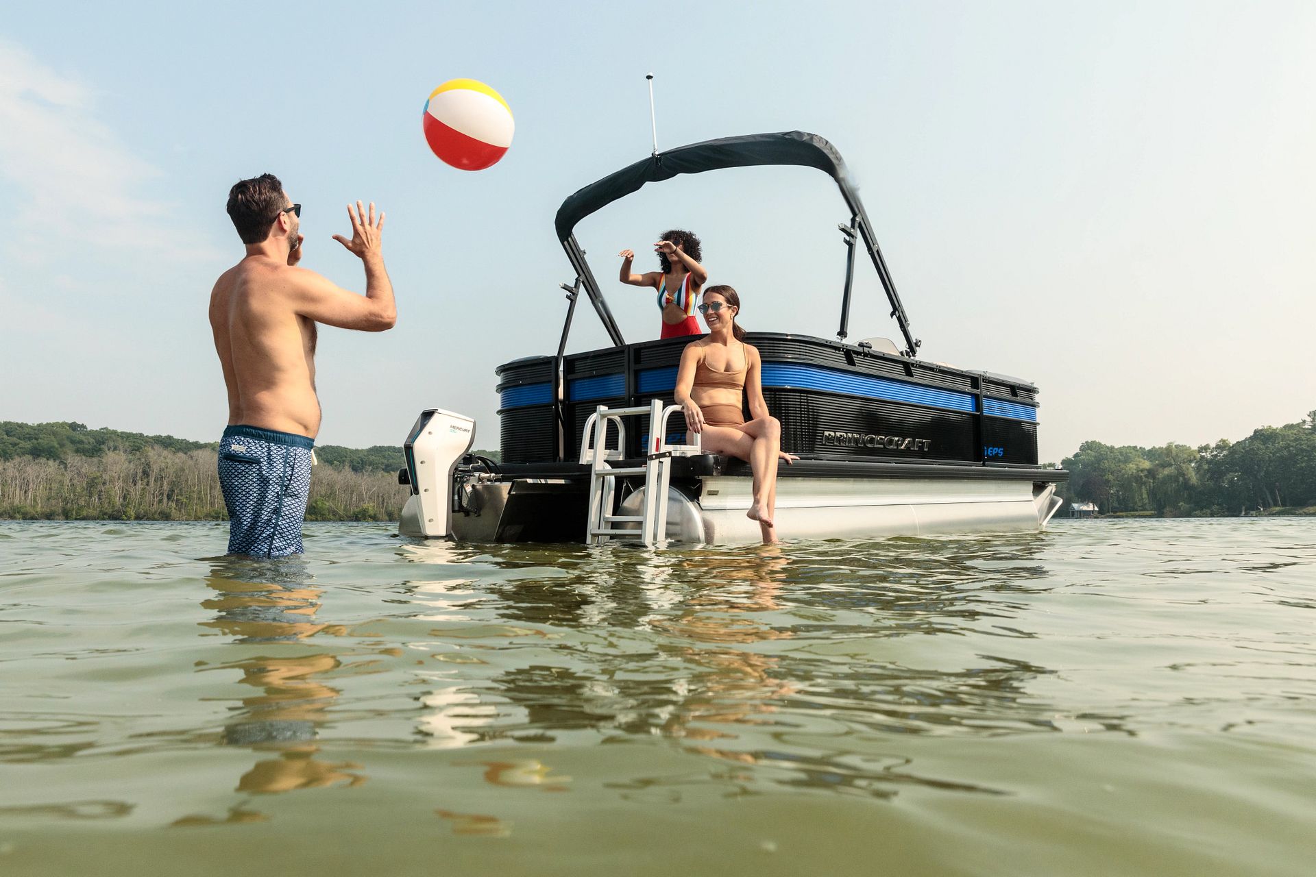 Pontoon boat in water with a electric mercury motor. Family having fun in the water.