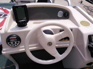 A boat with a steering wheel and a gps on it