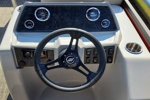 A close up of a steering wheel on a boat.