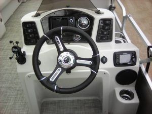 A boat with a steering wheel and controls on it.