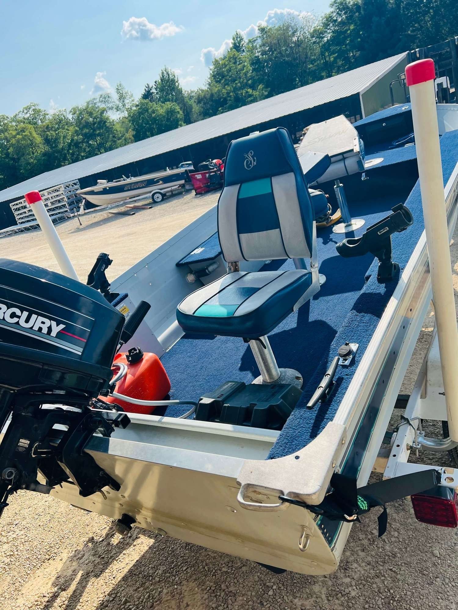A mercury outboard motor is attached to the back of a boat.