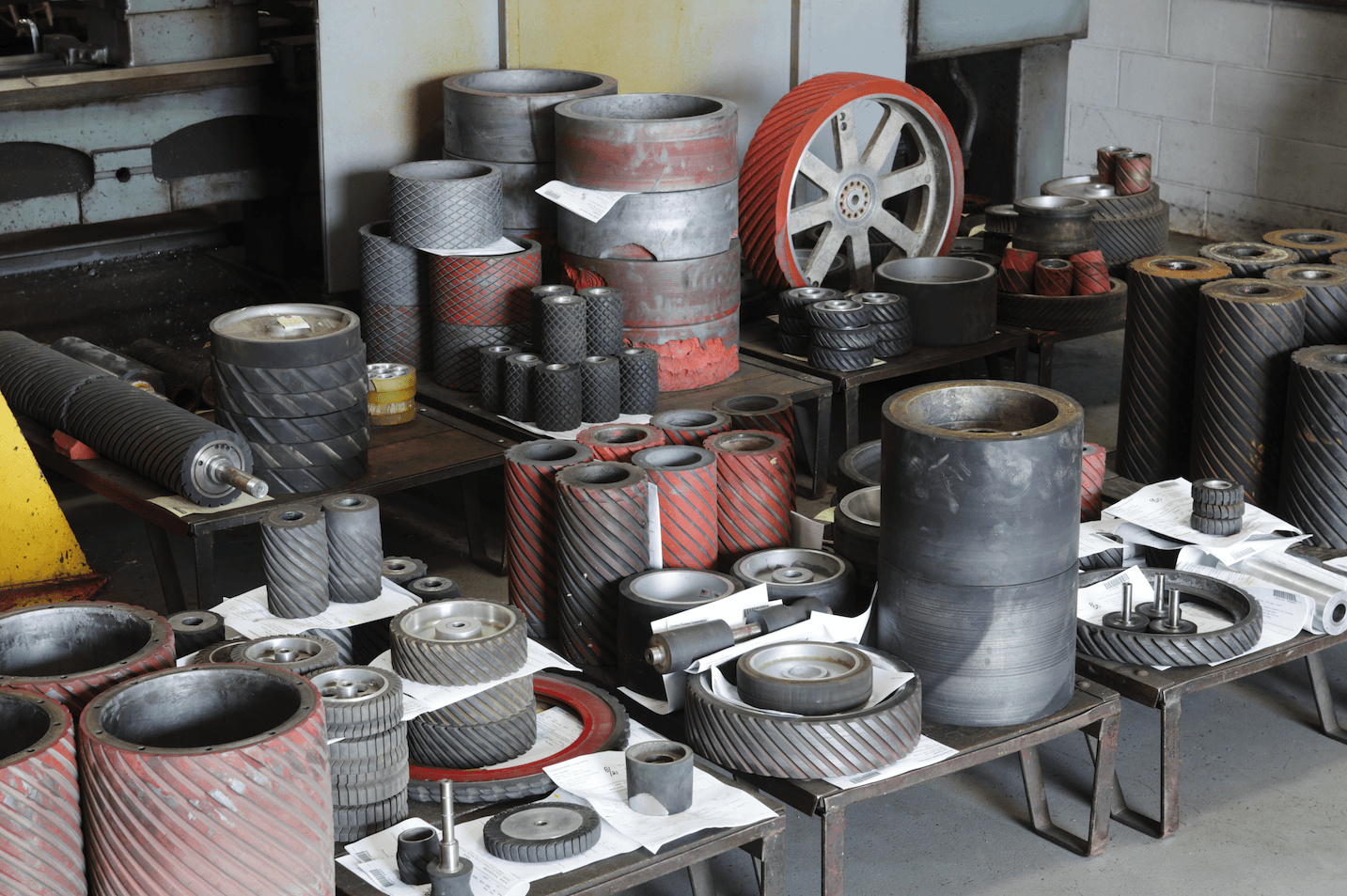 A warehouse filled with lots of cylinders and wheels