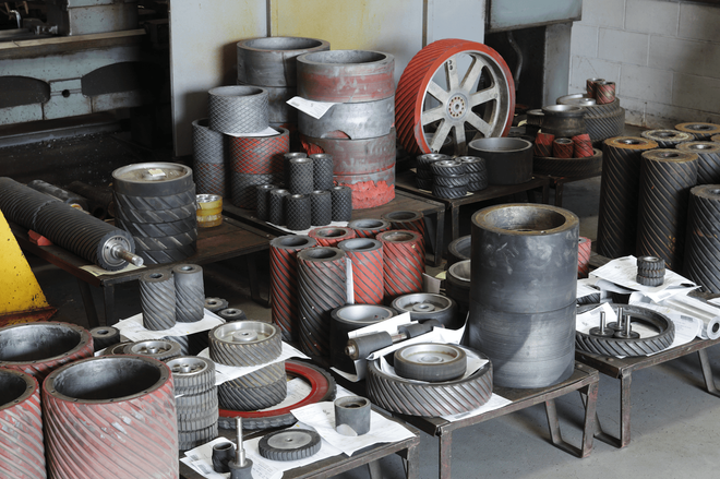 A warehouse filled with lots of cylinders and wheels
