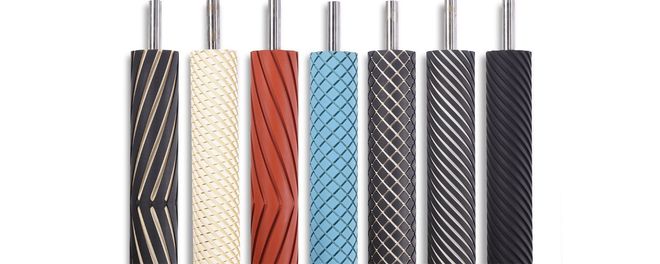 A row of different colored rollers with metal handles on a white background.