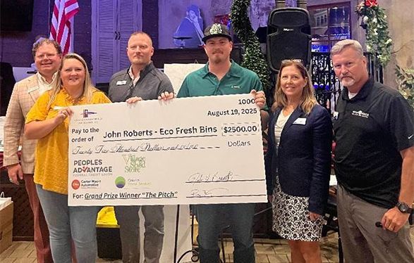 Group of people holding a large check.