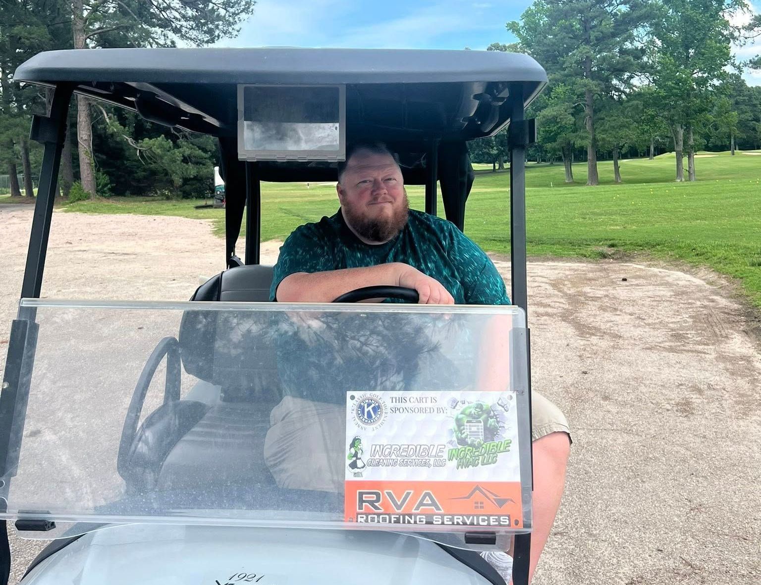A man is sitting in a golf cart with a sticker on the front that says RVA
