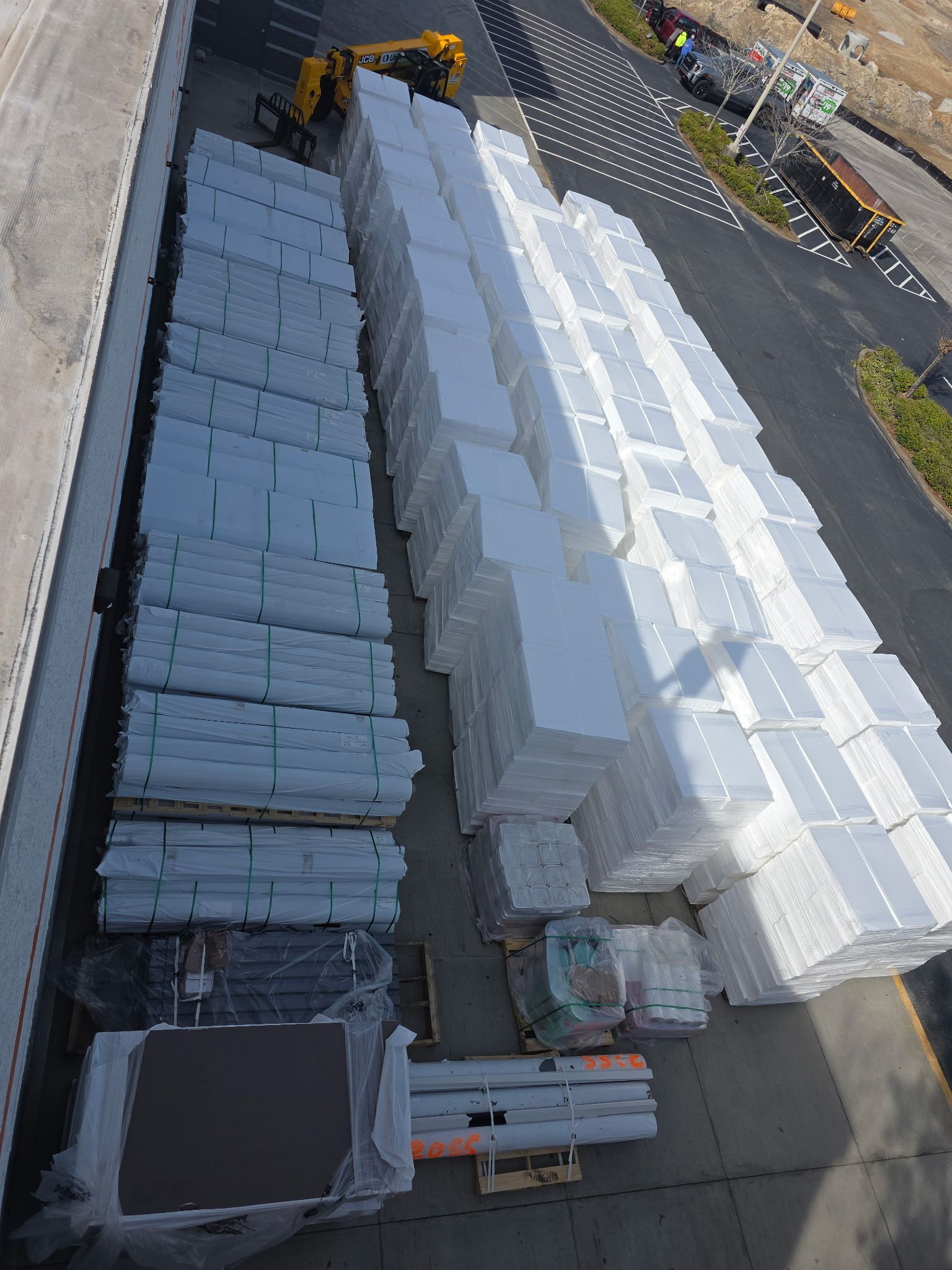 Trucks loaded with materials on construction site under a blue sky.