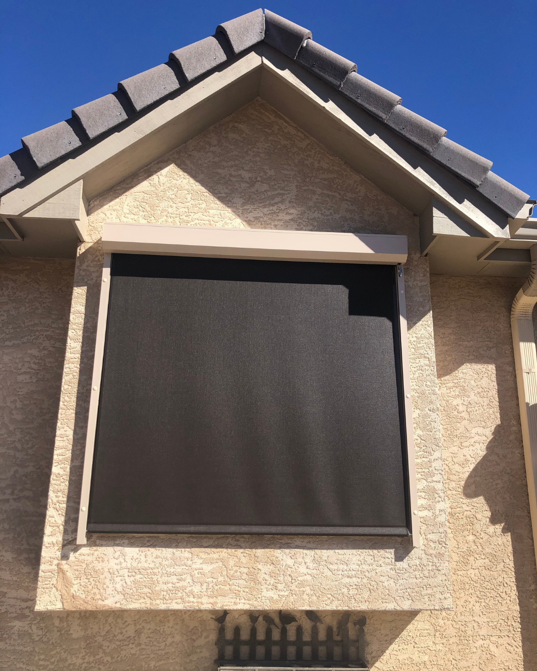 Black outdoor shade installed on upper window of Colorado Springs home
