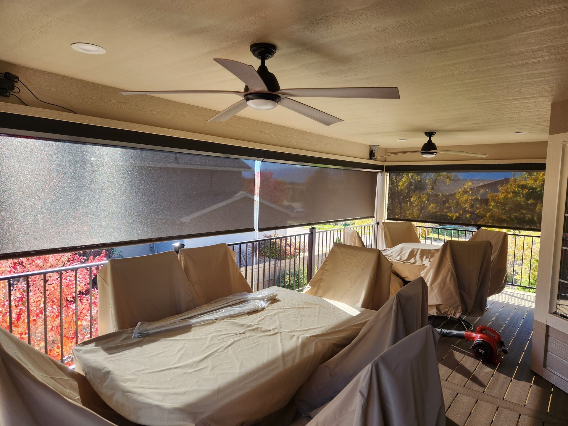 Motorized outdoor shades installed on a covered porch in Colorado Springs