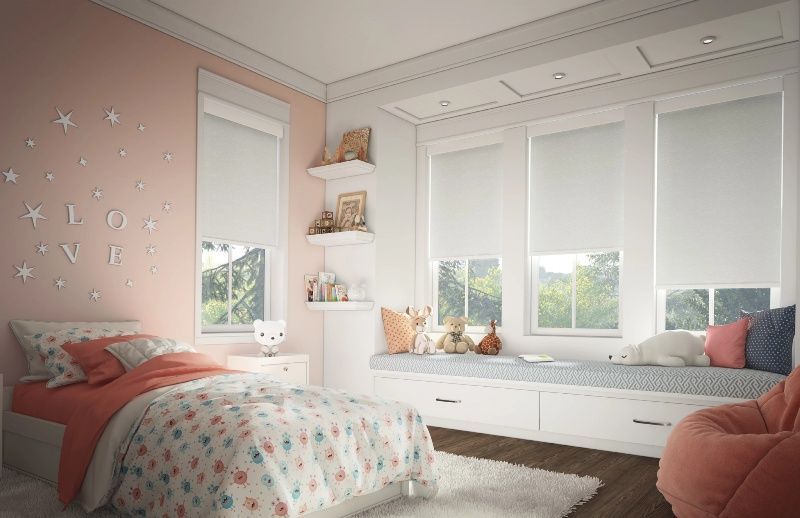 Cordless motorized bedroom shades in a pink and white themed child’s room