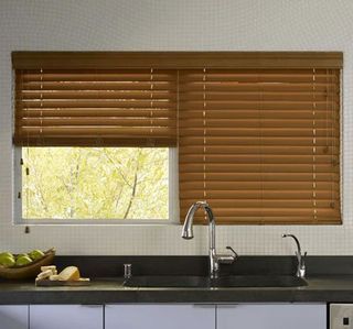 faux wood blinds above kitchen sink for classic style and moisture resistance
