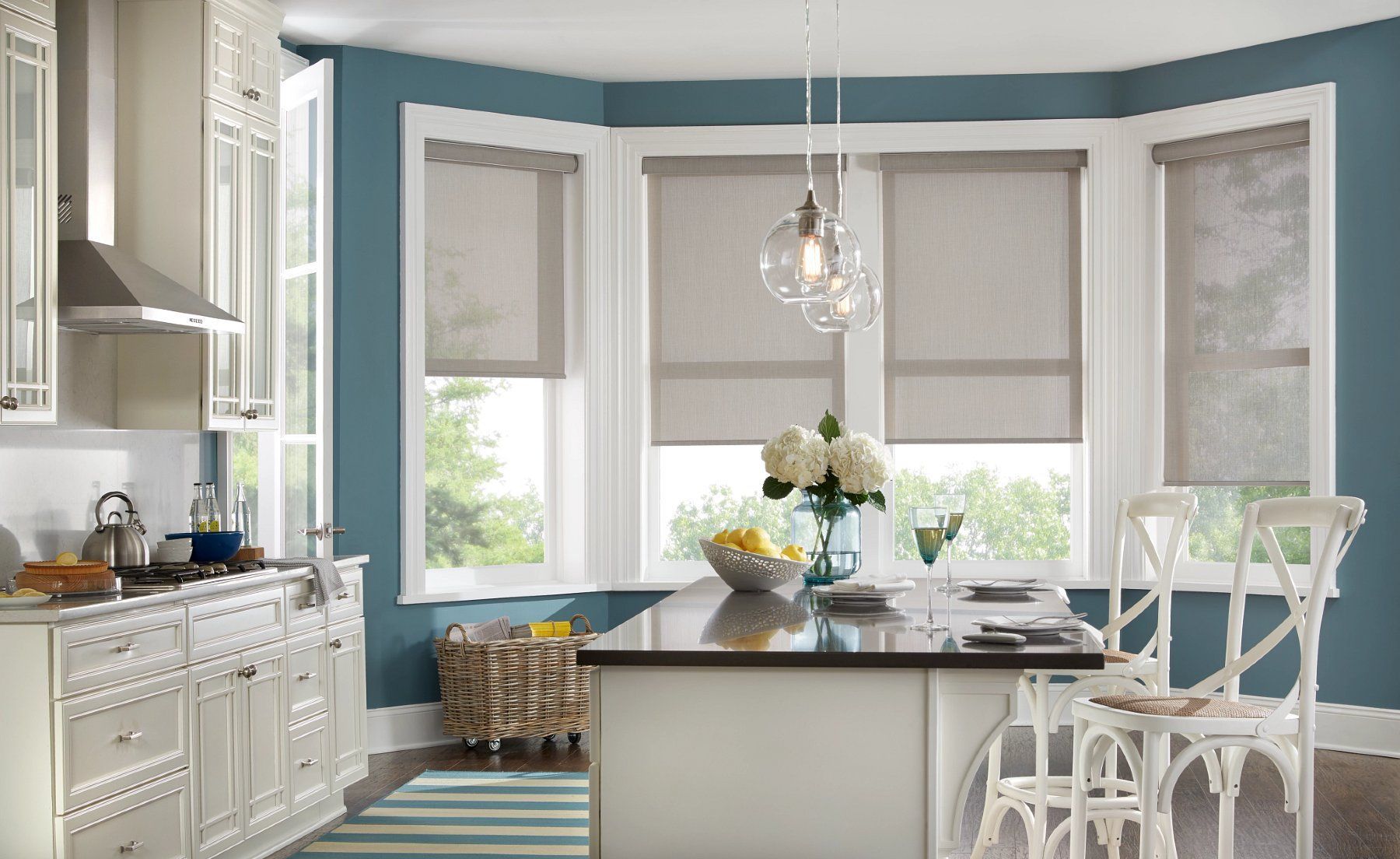 white Roman window shades installed in blue kitchen nook for soft classic window style