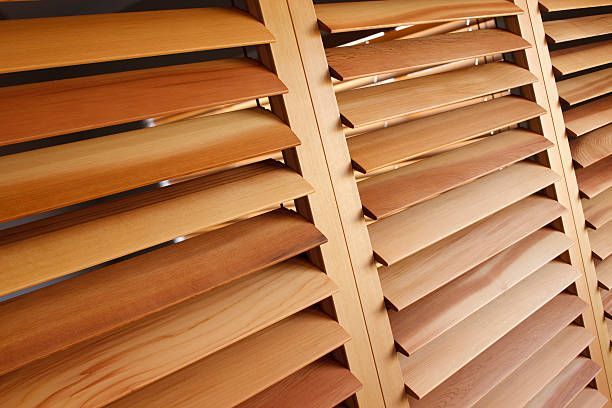close-up of natural wood plantation shutter slats showing grain and spacing detail