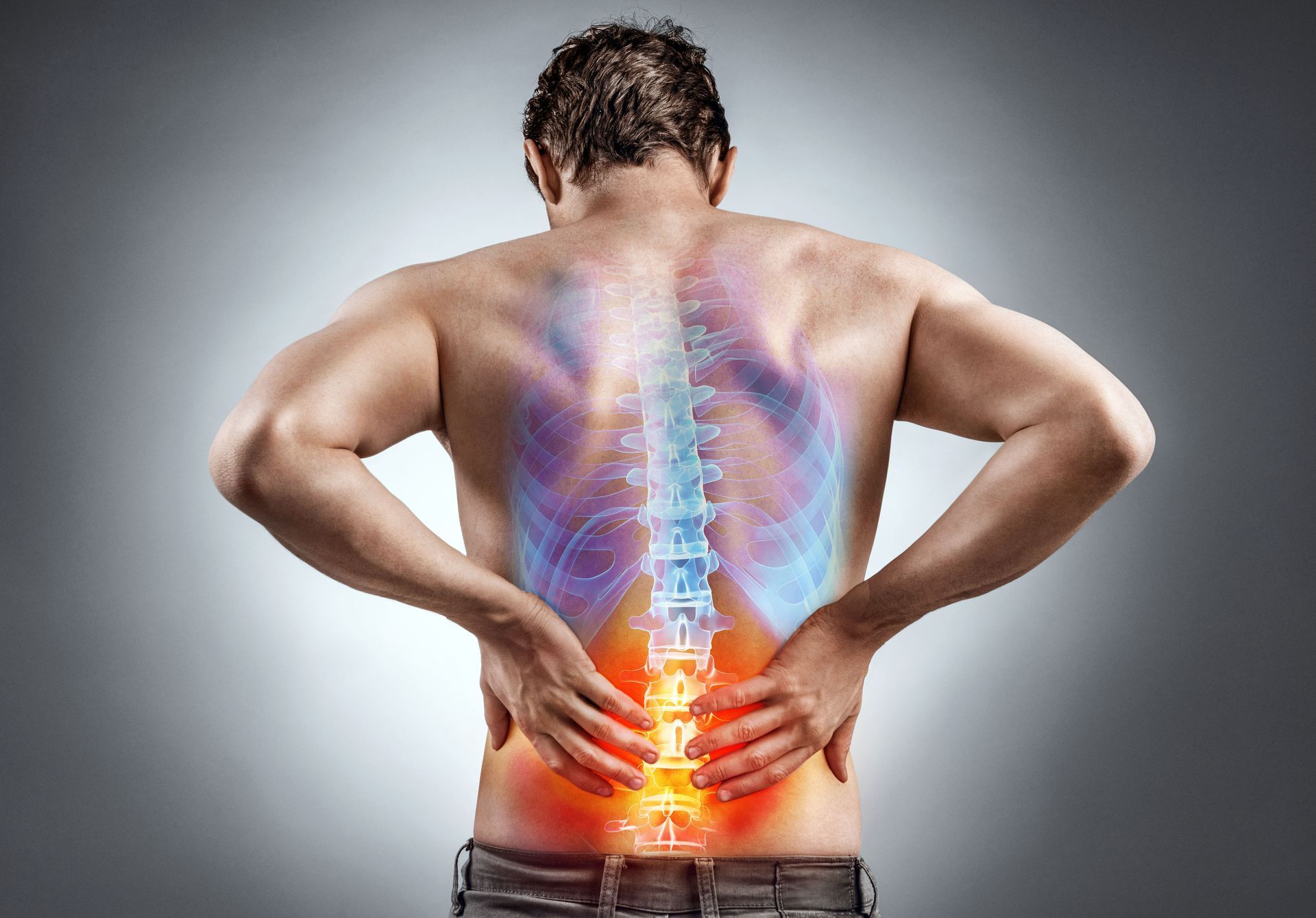 Man clutching lower back with glowing spine overlay, showing back pain