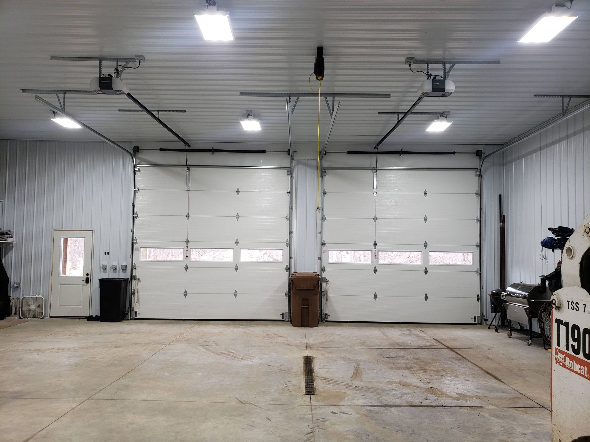 A large garage with a lot of white doors