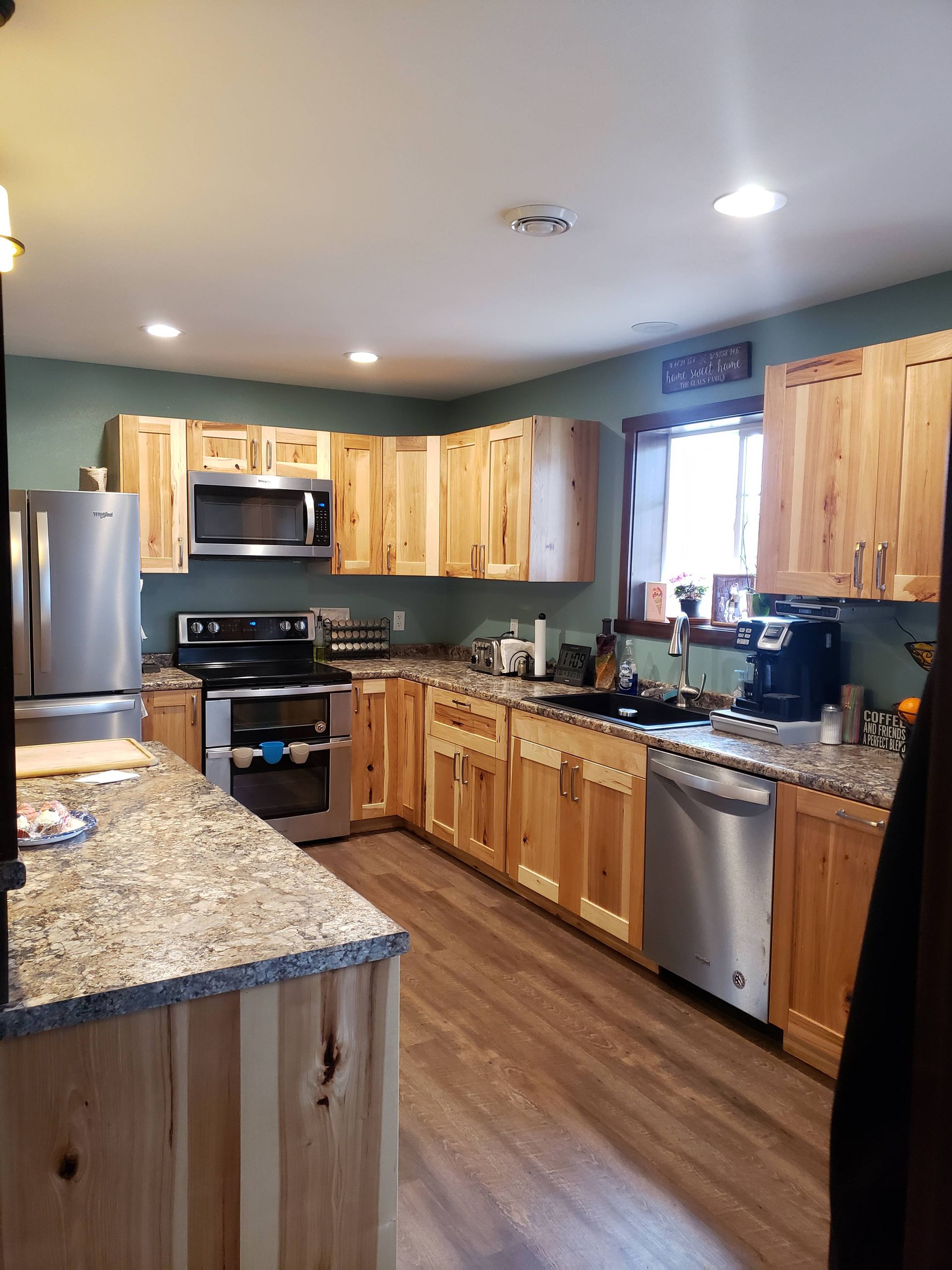 A kitchen with wooden cabinets and stainless steel appliances